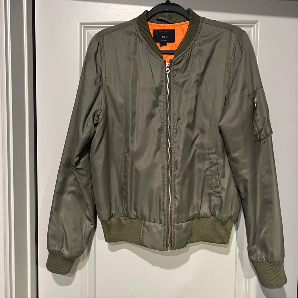 Woman’s bomber jacket, size (L). Color: Olive green with orange inside lining